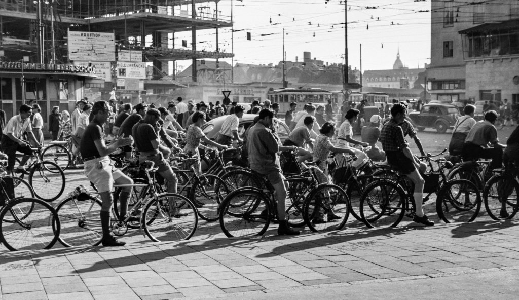 JOHN BAER The Extraordinary Ordinary: A Memoir in Photographs 1945-1954, John Baer, Cyclists in Traffic, Munich, 1951, from JOHN BAER The Extraordinary Ordinary: A Memoir in Photographs 1945-1954.