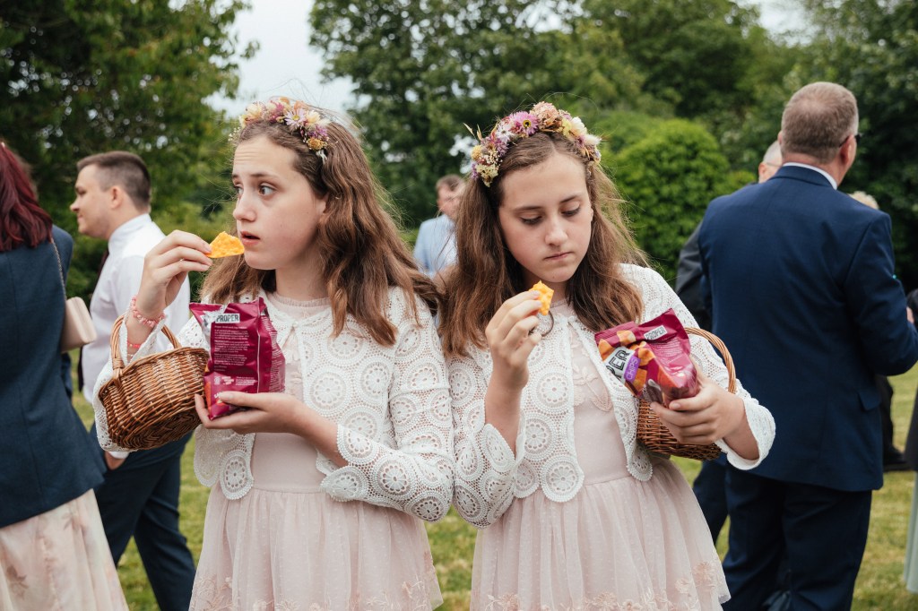 World Food Photography Award, Champagne Taittinger Wedding Food Photographer catgory winner. Twin Bridesmaids Enjoy Canapés, Devon, UK by Emma Stoner, UK
