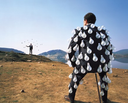 man wearing a suit covered in light bulbs