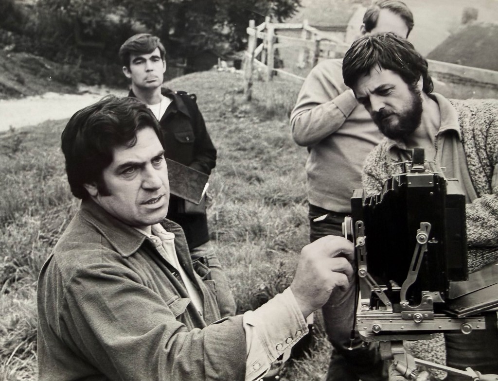 three men with a camera