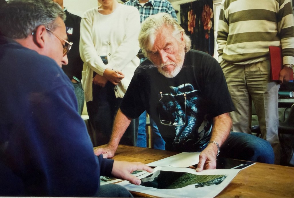 two men looking at a photo