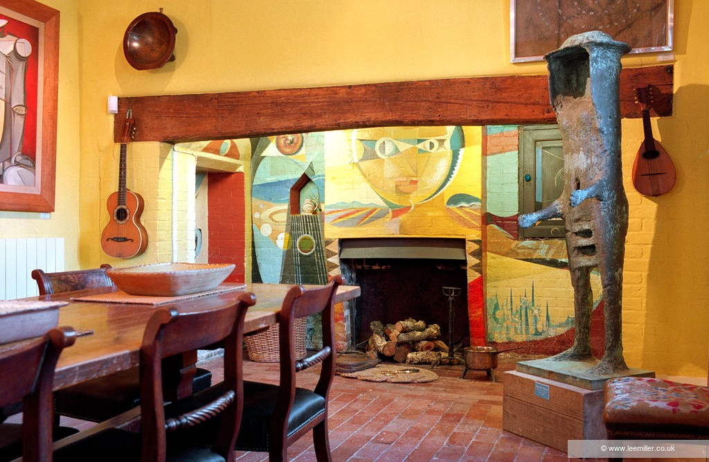 bright mural in the fireplace at lee millers home