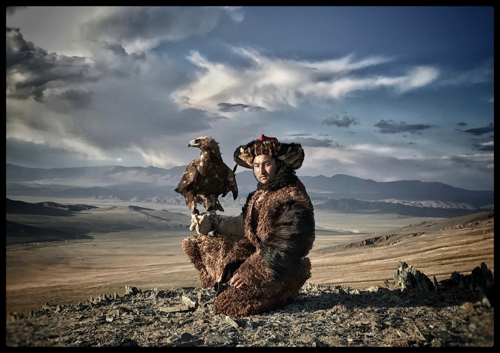 photo of an eagle hunter with a bird on his arm
