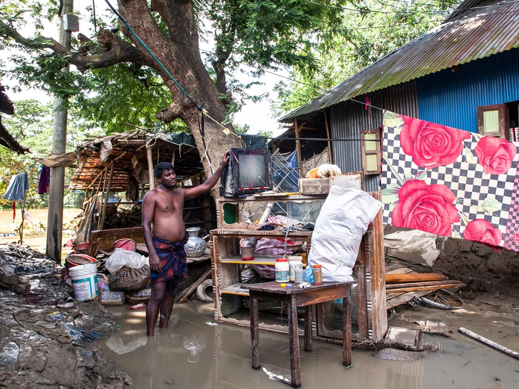A man examines damaged belongings after floodwaters receded in Chhagalnaiya upazila, Feni district, Bangladesh, on August 29, 2024.
