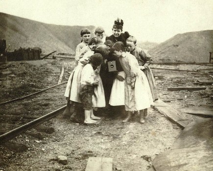 children gathered around a Kodak camera in 1890