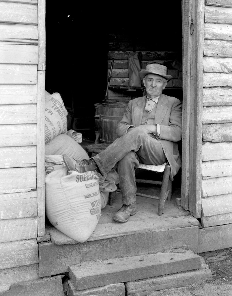 Mill worker at sitting by the door