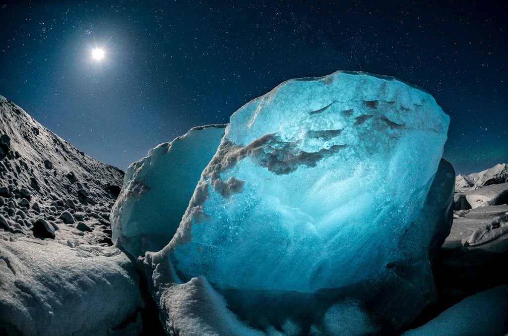 landscape photo of a large diamond shaped piece of ice