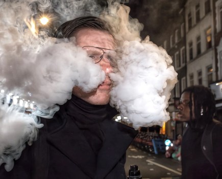 man blowing smoke out his nose