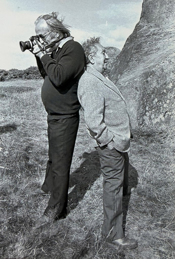 two men with a camera