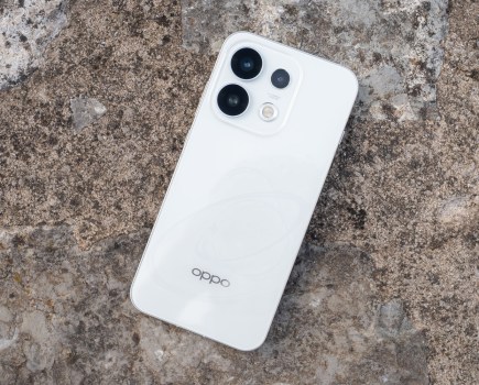 White Oppo Reno 16 pro placed on a grey rock