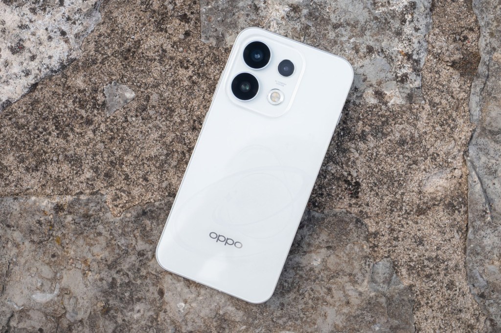White Oppo Reno 16 pro placed on a grey rock