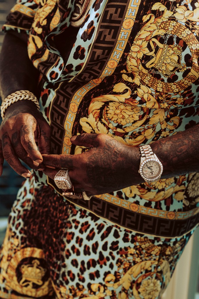 Rick Ross wearing a Rolex Day-Date flooded in aftermarket diamonds