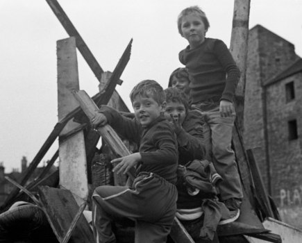Children playing on top of rubble