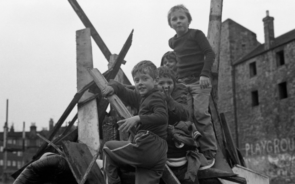 Children playing on top of rubble