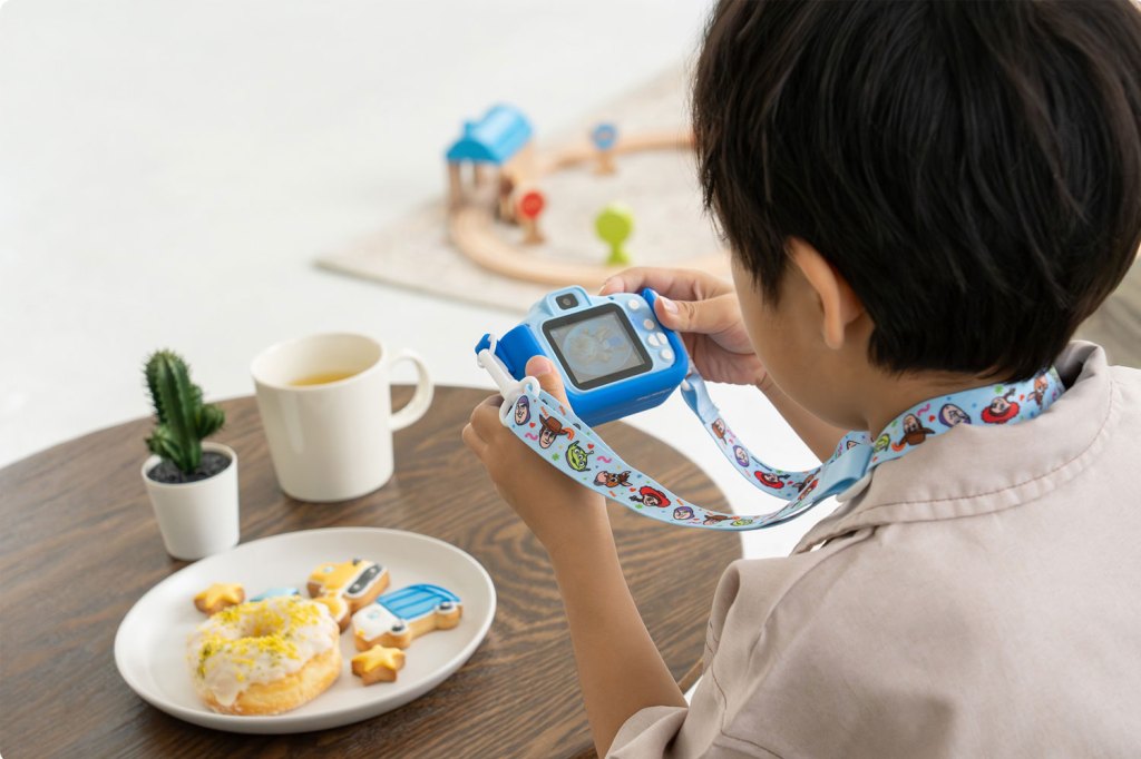 Kenko Tokina Toy Story kids camera. A boy holds a small toy camera