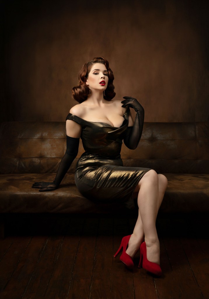 A woman in a tightly fitting outfit sitting on a sofa