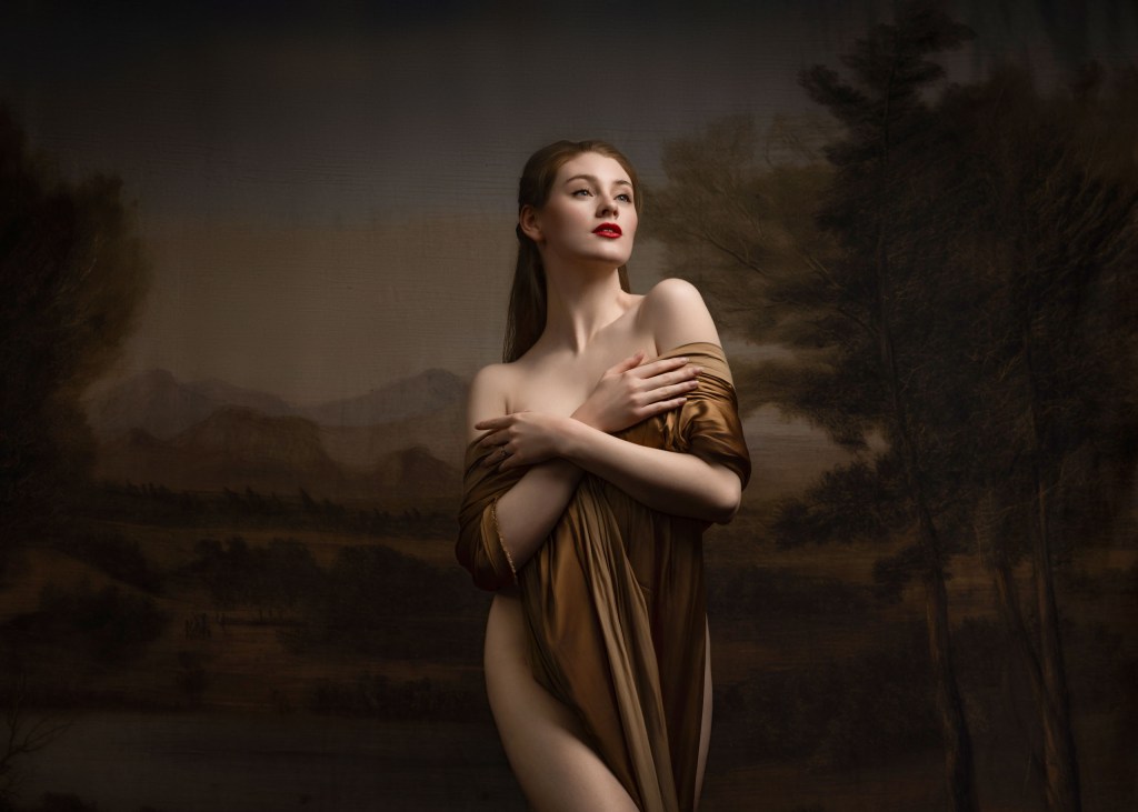 A woman posing in front of a dark background