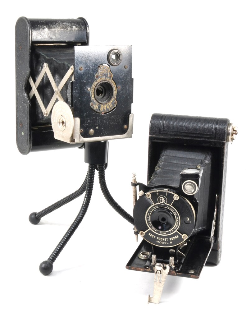 In 1912, the Vest Pocket Kodak was the first camera to use 127 size film. The original model is pictured on its now rare tripod attachment, alongside the newly designed Model B that followed in 1925