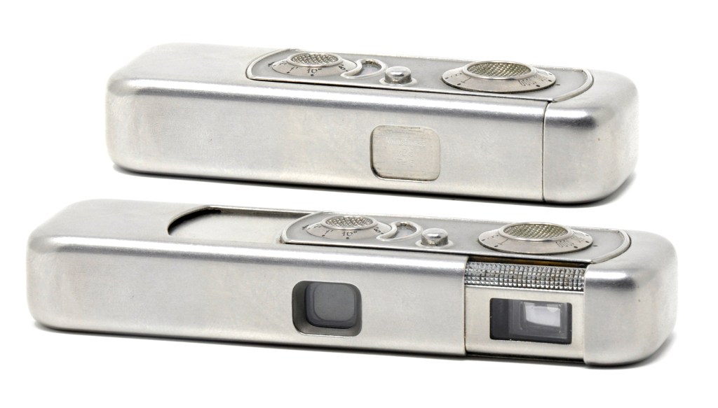 Shown here in its open and shut positions, this is first Minox today known as the Riga model, named after the town in Latvia where it was built in 1937. The body was made of stainless steel and, like the various models that followed, the photographer pulled on one end to extend the body, took the picture and then snapped it shut again, an action which also tensioned the shutter and advanced the film. Following World War II, later models were made of aluminium and manufactured in West Germany