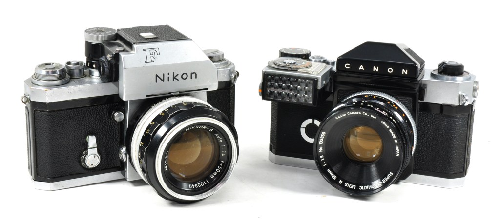 Two Japanese pioneering 35mm SLRs from 1959: the Nikon F (left) and Canonflex. The Nikon is shown with its Photomic head introduced in 1961 to offer match-needle metering
