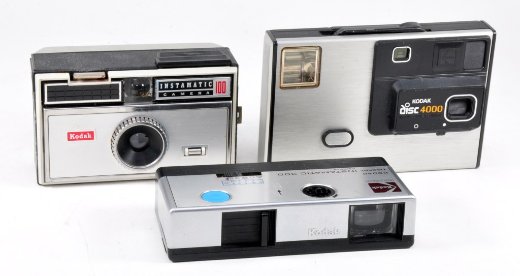 Three generations of Kodak snapshot cameras: the Instamatic 100 for 126 film, Pocket Instamatic for 110 film and the first Disc Camera