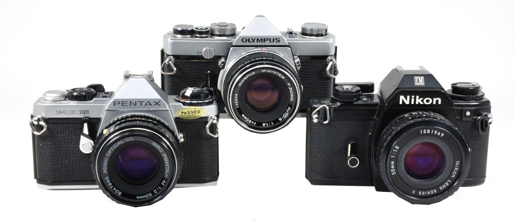 The original Olympus M-1 with Pentax ME Super and Nikon EM