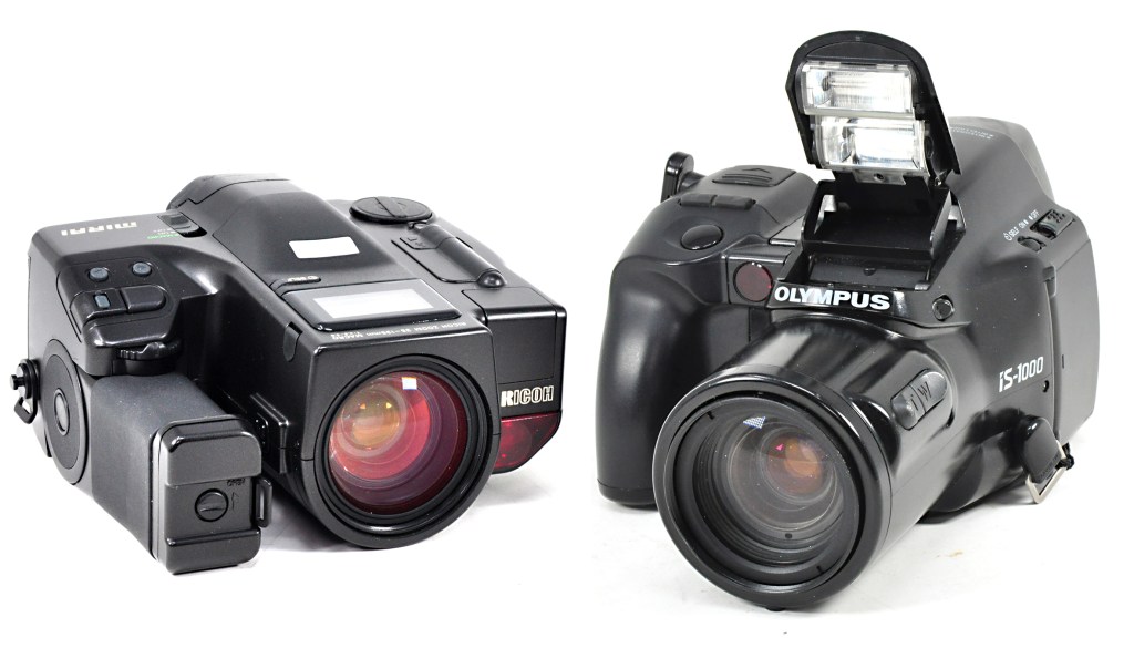 Two different bridge camera designs: the 1988 Ricoh Mirai and 1990 Olympus IS-1000