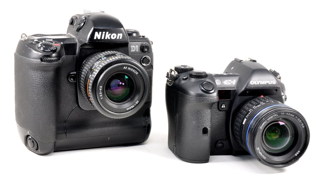 Two DSLRs that strongly influenced future digital designs: the Nikon D1 and Olympus E-1