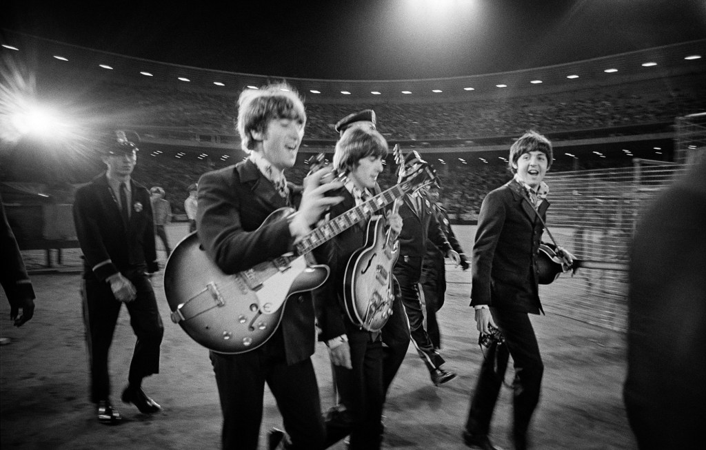 The Beatles walk across the field to the
stage at Candlestick Park. Image Credit: 2026 © Jim Marshall ONE TIME USE