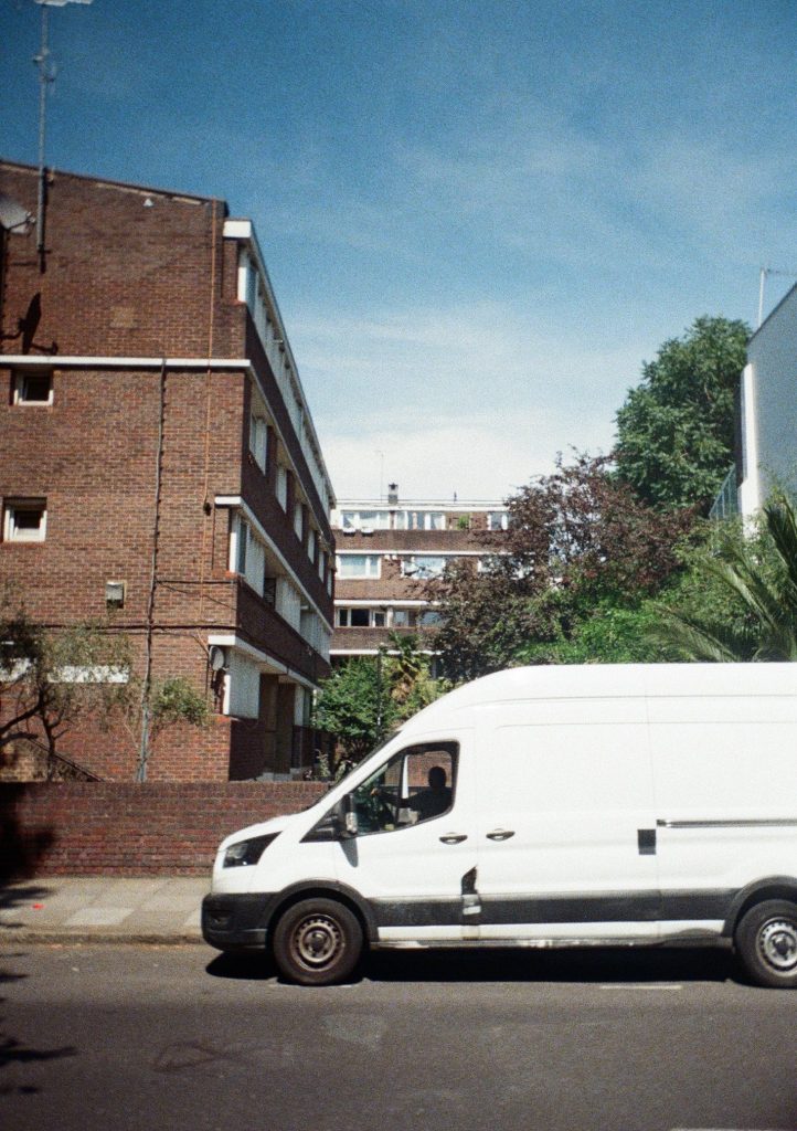Sample photograph from the Lomography Half-frame Simple Use Camera, shot on Lomo Color Negative 400 film, showing a white van parked outside a housing estate