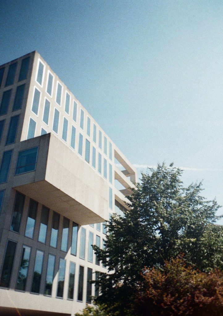 Sample photograph from the Lomography Half-frame Simple Use Camera, shot on Lomo Color Negative 400 film showing a tall blocky building and a tree
