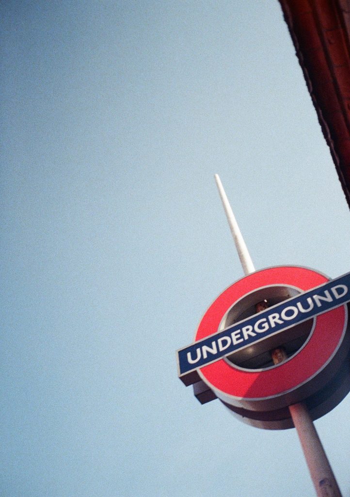 Sample photograph from the Lomography Half-frame Simple Use Camera, shot on Lomo Color Negative 400 film showing a London Underground sign against a blue sky