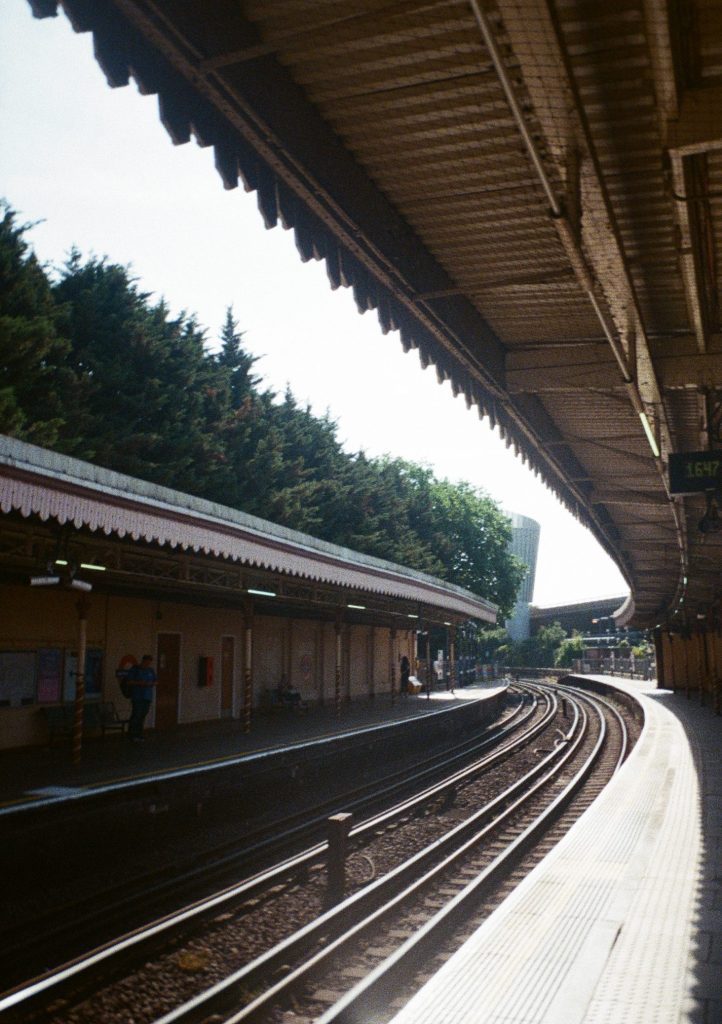 Sample photograph from the Lomography Half-frame Simple Use Camera, shot on Lomo Color Negative 400 film showing a station platform and train lines