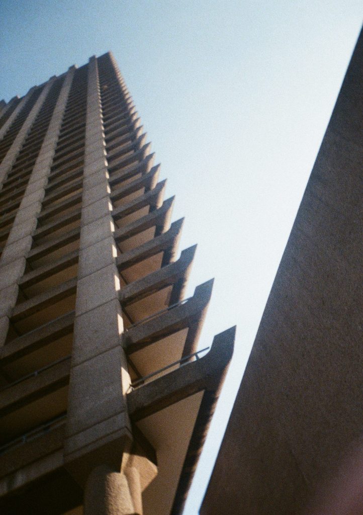 Sample photograph from the Lomography Half-frame Simple Use Camera, shot on Lomo Color Negative 400 film showing a Barbican tower shot from below