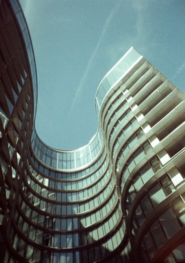 Sample photograph from the Lomography Half-frame Simple Use Camera, shot on LomoChrome Classicolor 200 film showing a tall curved building from below