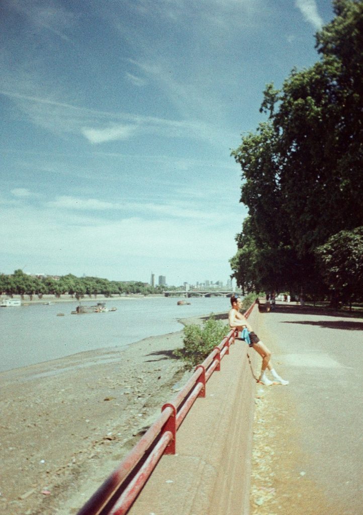 Sample photograph from the Lomography Half-frame Simple Use Camera, shot on LomoChrom Classicolor 200 film showing shirtless man leaning on a wall by the River Thames