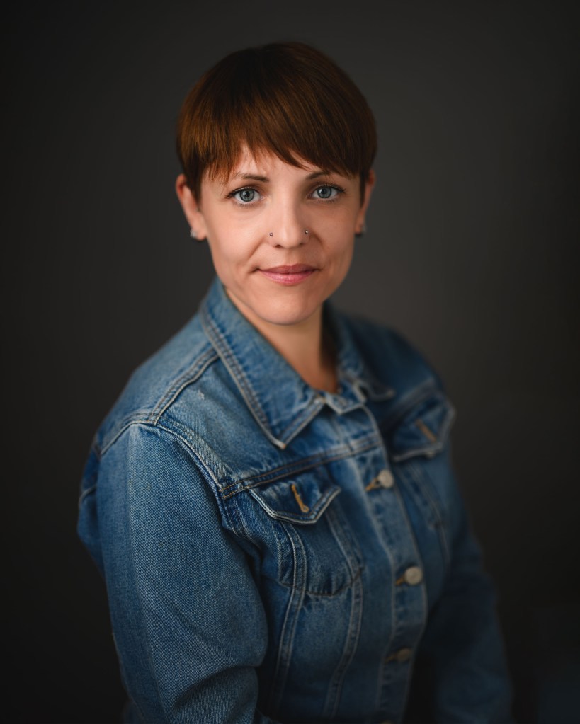 A portrait of a woman wearing a denim jacket