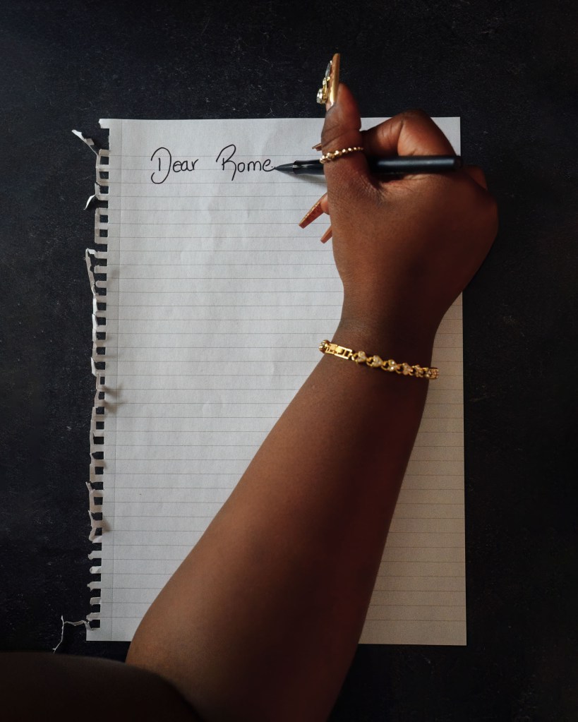 A hand writing a letter