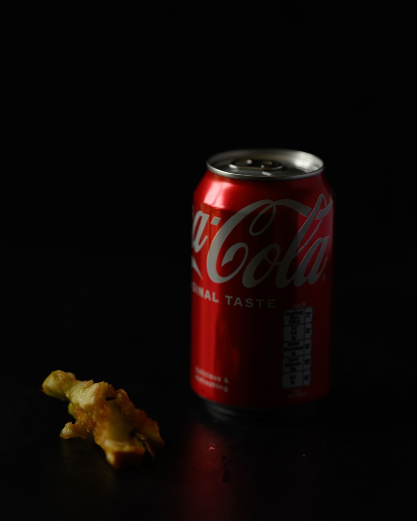 A still life of a Coca Cola can