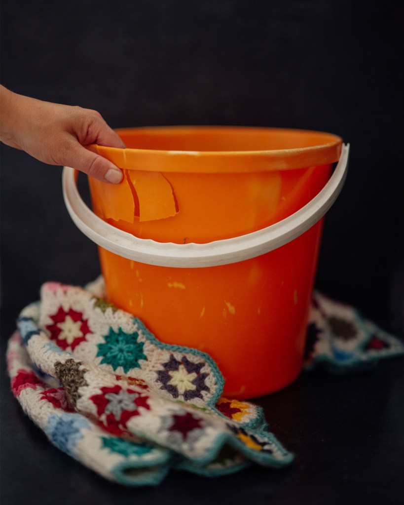 A still life of a bucket and a blanket