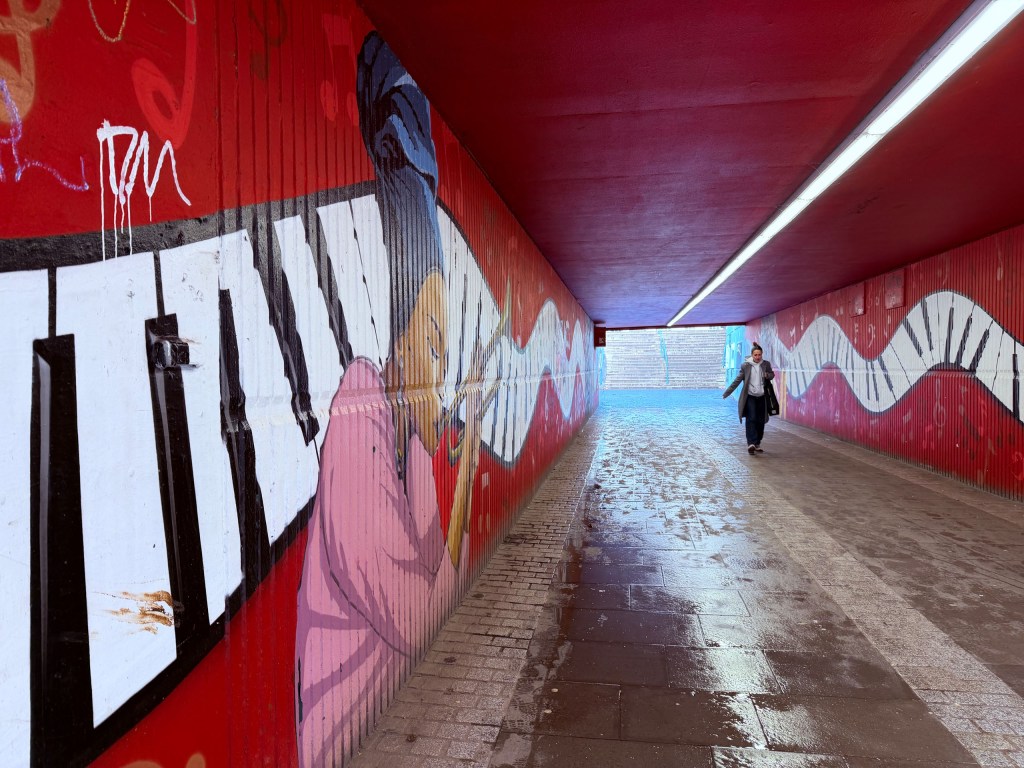 A person walking through an underpass