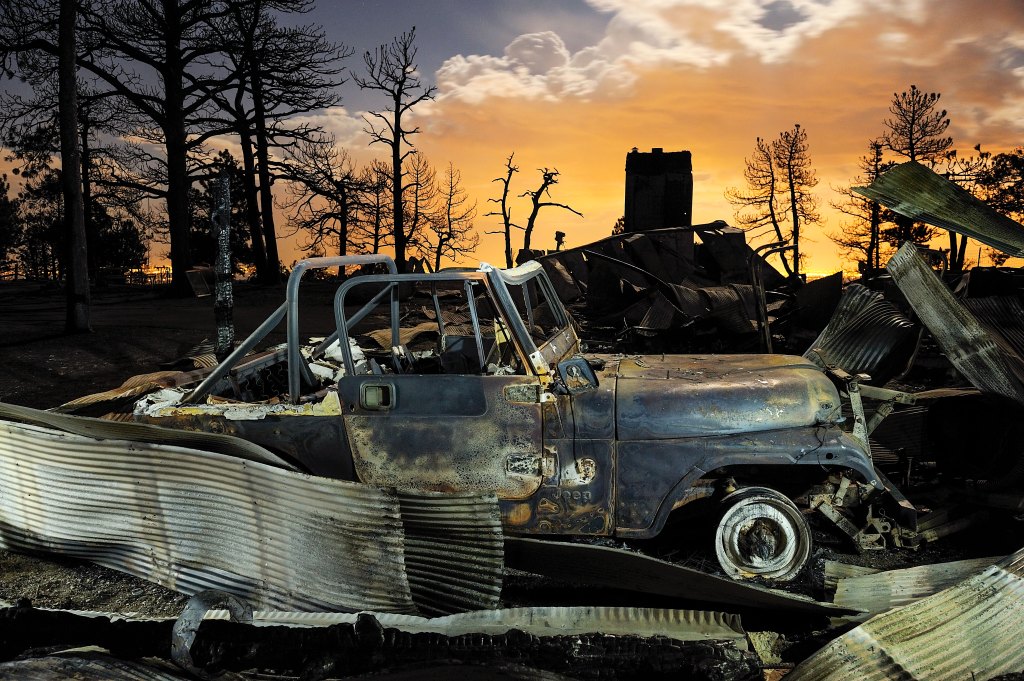 Aftermath of forest fire, burnt out car