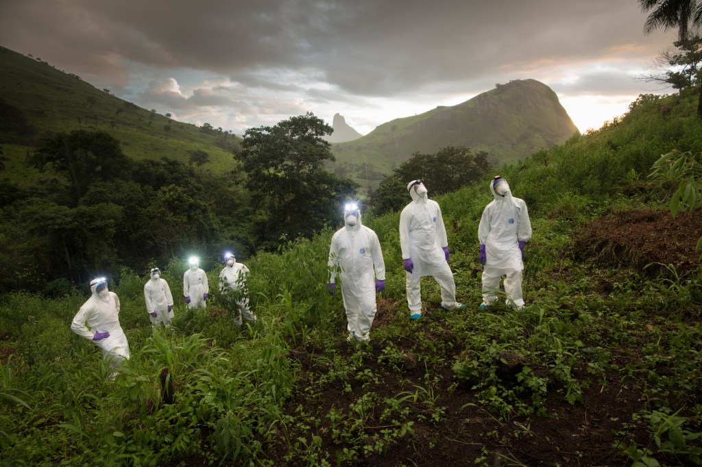 From Ebola to swine flu to HIV/Aids, viruses borne by animals have caused some of the most devastating epidemics in history. What will come next? In Sierra Leone, scientists work to find Disease X – a virus that is as yet undiscovered, but which could have the potential to ravage populations.In advance of the Covid 19 pandemic scientists from the USAID Predict project slog through the jungle to trap and test bats, looking for new strains of the Ebola virus and other deadly pathogens in the wild animal population. In the sweltering heat and tropical downpours on the mountainous Guinea border PPE clad workers conduct their search. Image Credit © Simon Townsley