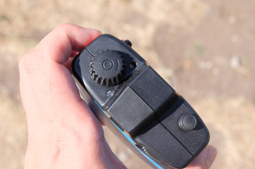 Photograph of the Lomography Half-frame Simple Use Camera from the top showing rewind dial and shutter nutton