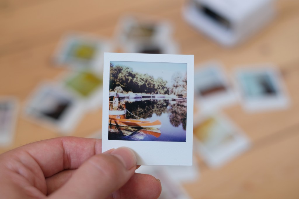 Polaroid Go photograph of boats on a reiver