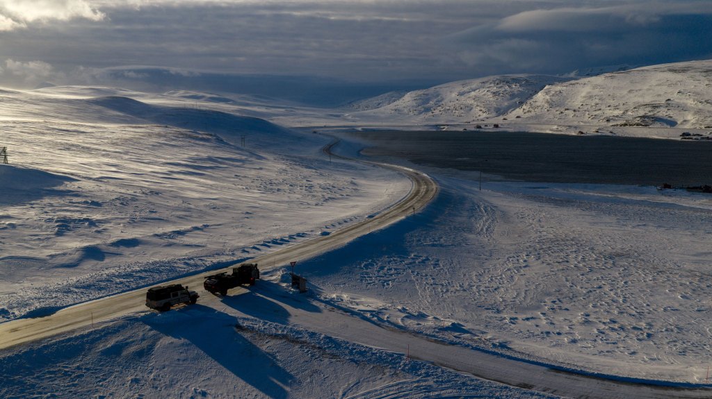 aerial image of two cars in a icy landscape