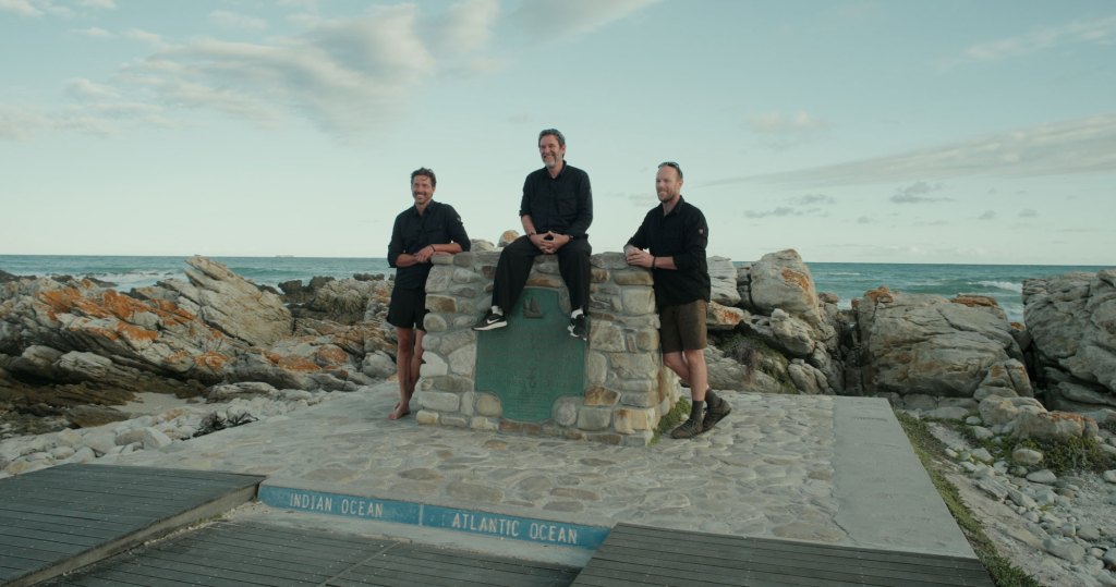 three man pose at the plaque marking southernmost point of africa