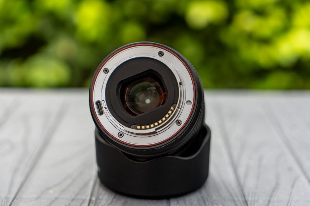 Viltrox AF 35mm F1.8 EVO II positioned askew on top of its lens hood, with the mount showing