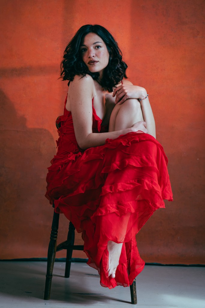 Portrait of a woman sat in a red dress