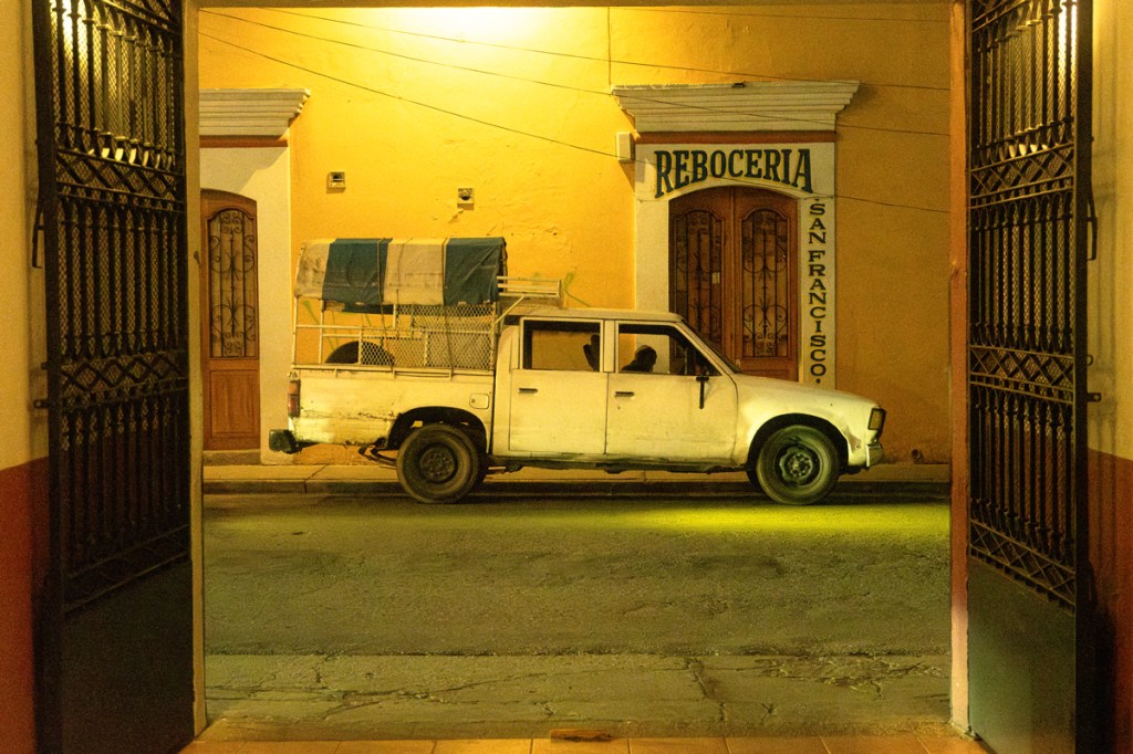 photo os a white pick up truck at night